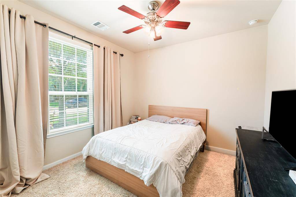 Cozy front bedroom located just off the entry, with a nearby full bath and second bedroom along the same hallway.