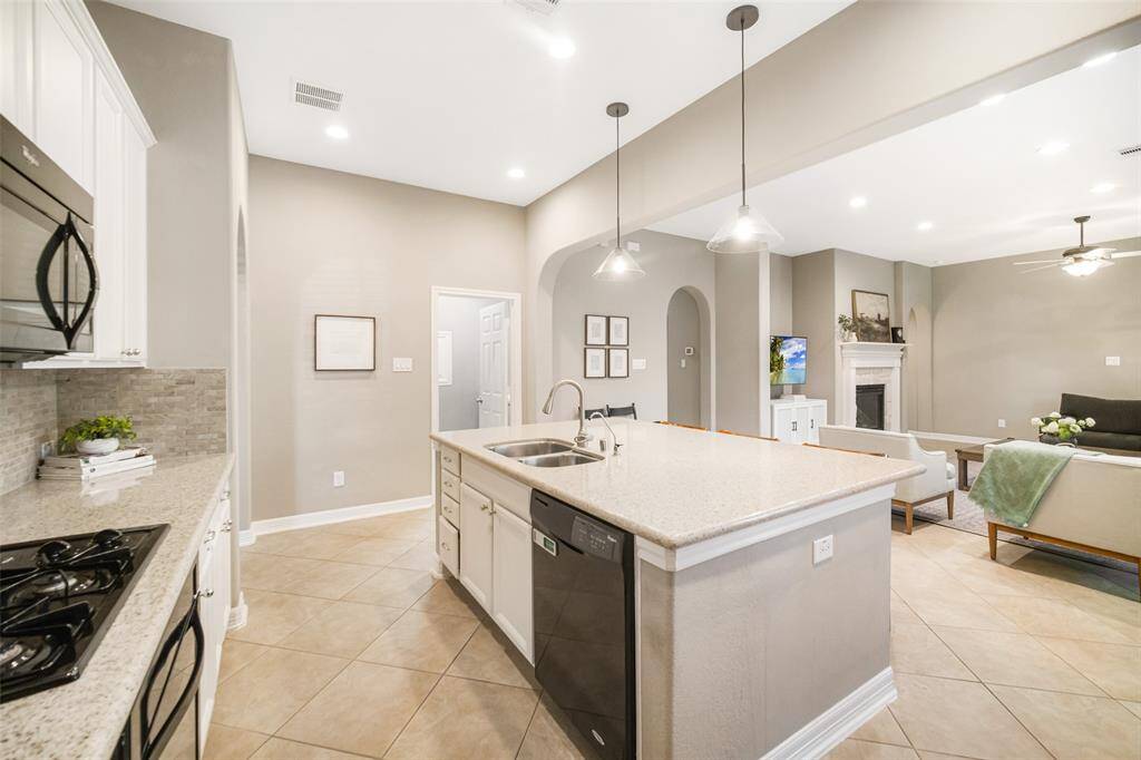 The kitchen offers gas cooking, a deep double sink, and it is wonderfully open to the family room.  The cabinets were recently professionally painted.