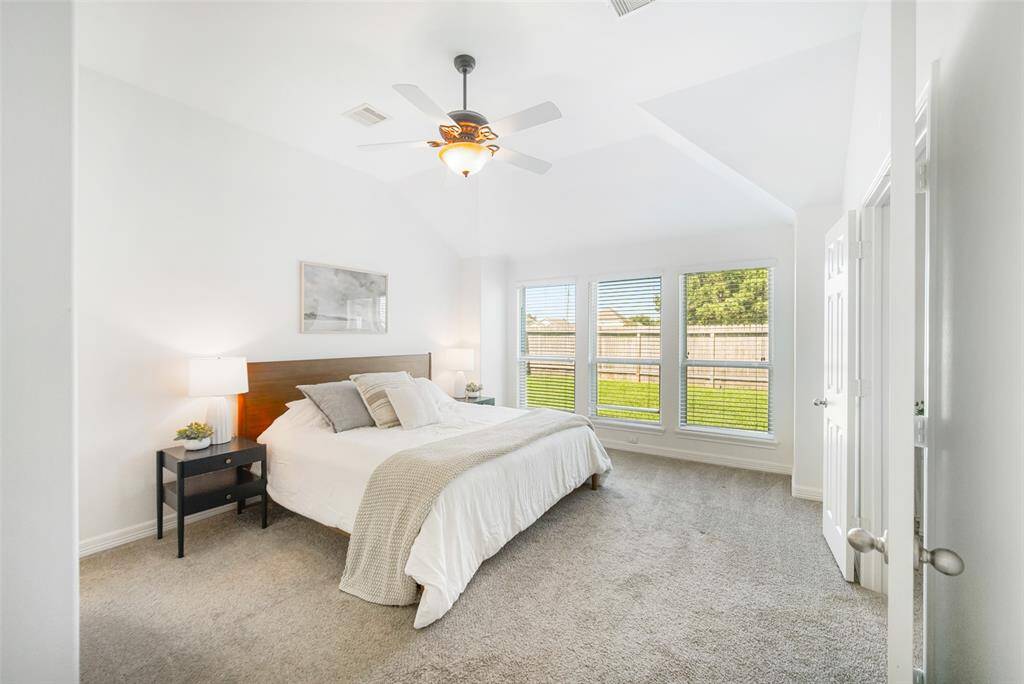 Step into the primary bedroom and you will be impressed by the high ceilings and large windows. In this spacious bedroom, there's room to add whatever furniture you like!