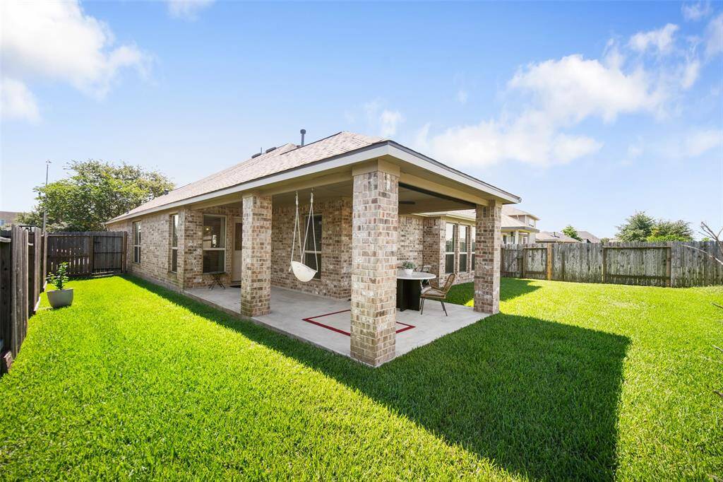 The back patio is a shady spot with plenty of room for outdoor dining and lounging.
