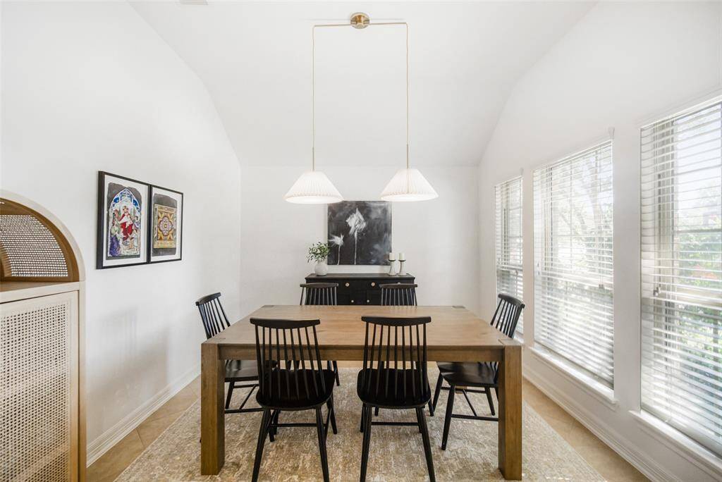 On the right as you enter the home is this cozy dining room that is perfect for entertaining. The pendant lighting is a recent upgrade and adds an elegant touch.
