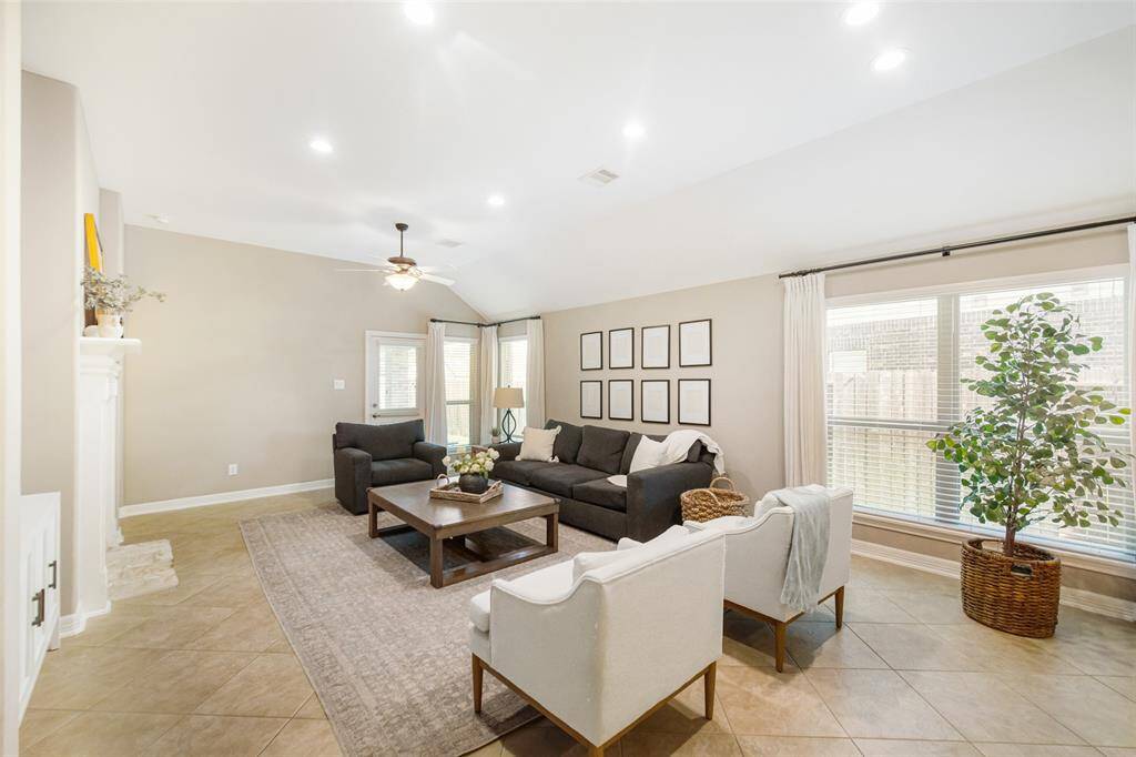 Step into the light and bright home and be greeted by neutral paint and tile floors in this wonderful family room.  The sellers recently added recessed ceiling lights to add even more light.