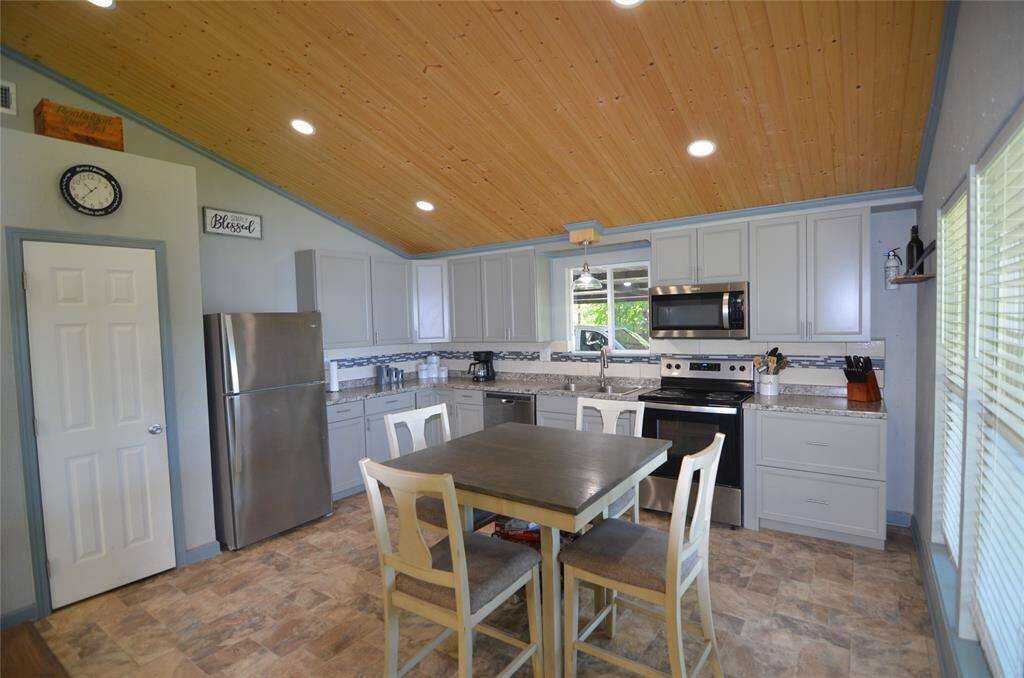 View of Kitchen/Breakfast Area. Recessed Lighting and Pine Bead board Ceilings