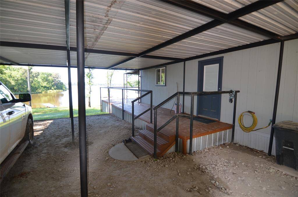 The Porch wraps around from front. (this section is 22'x7') There is a 2nd entry door to the property from the covered carport for rainy day weather etc.