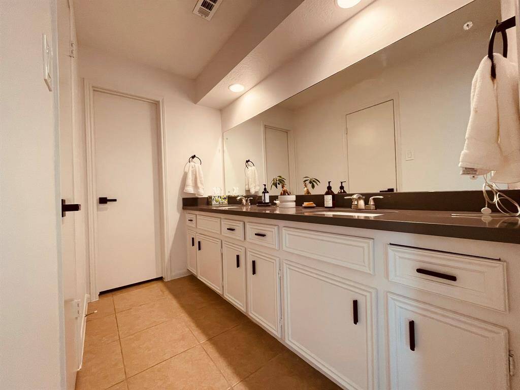 Master bathroom, with walk-in closet to the left and shower and toilet to the back door.