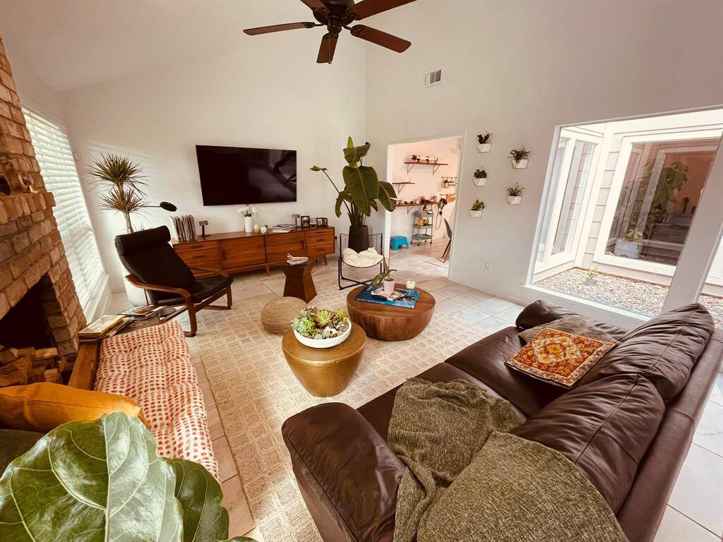 Living Area in between the attrium and the back yard with a real wood fire place.