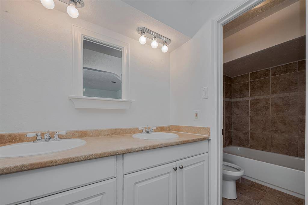 Primary bathroom offers both tub and shower combo.
