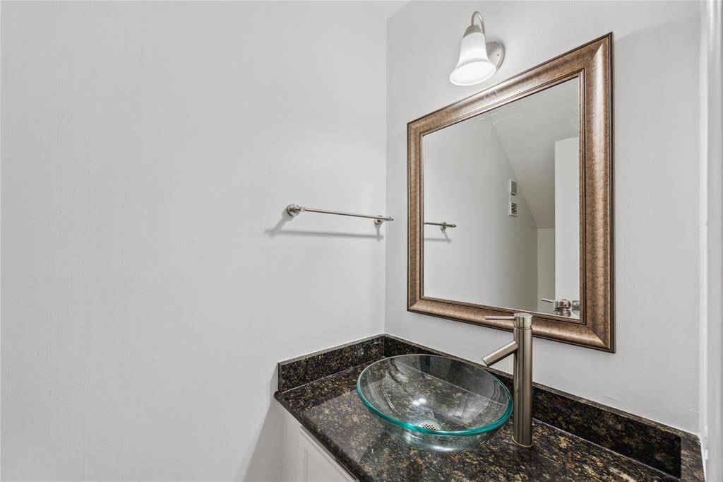 Stylish half bath conveniently located for guests, featuring modern fixtures and a clean, timeless design