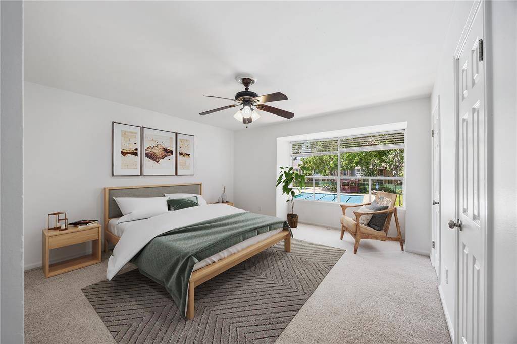Spacious bedroom retreat overlooking the pool, filled with natural light from an oversized window, a serene setting to start and end your day