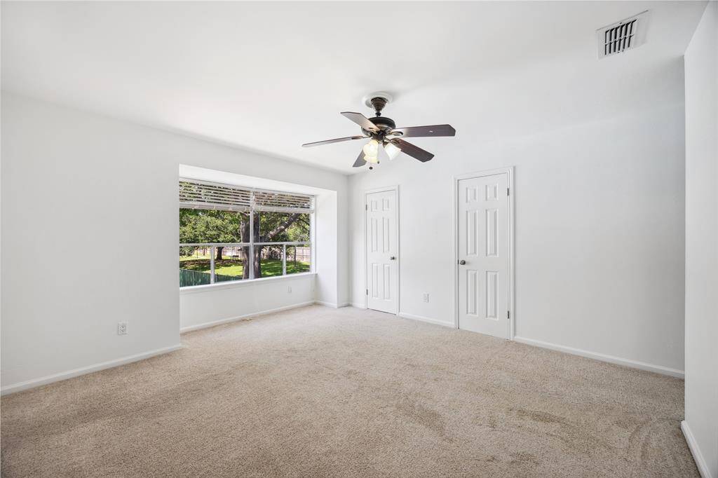 Spacious bedroom retreat overlooking the pool, filled with natural light from an oversized window, a serene setting to start and end your day