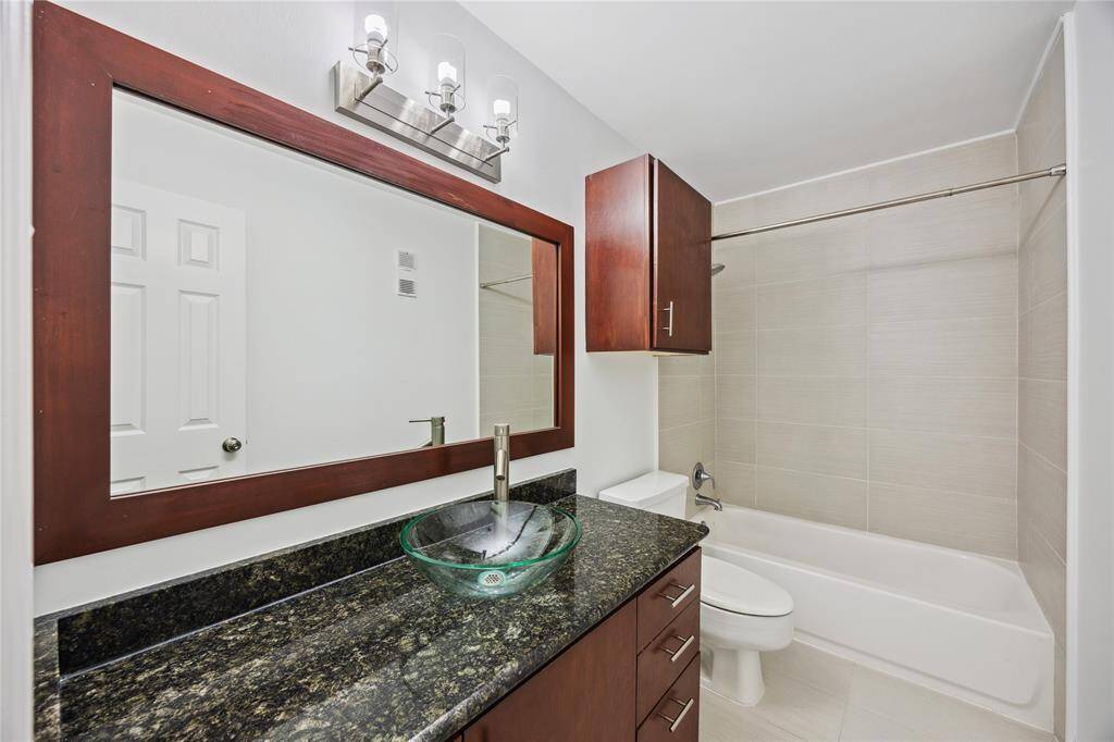 Versatile bath complete with a sleek shower/tub combo, designed for comfort and functionality