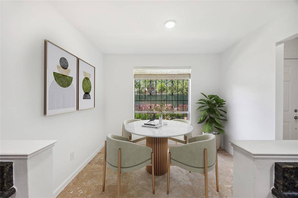 Bright and inviting dining room featuring a large picture window that fills the space with natural light — perfect for everyday meals or elegant entertaining."