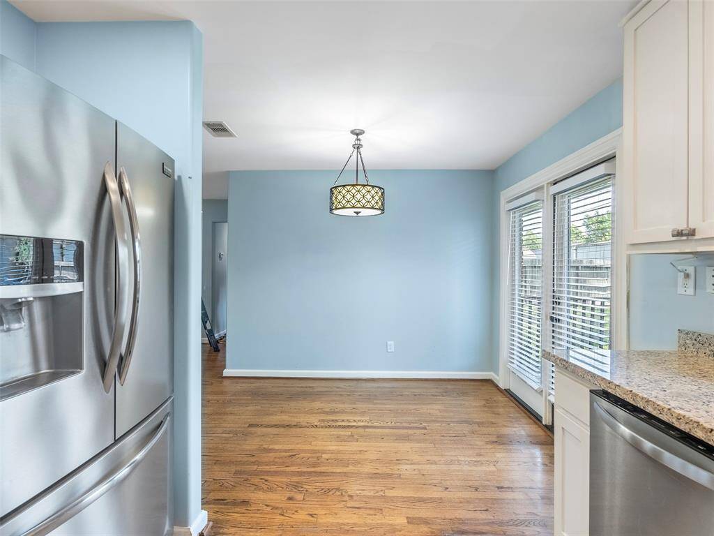 View of the dining room from the kitchen... if you can see past this HUGE fridge with water/ice maker!