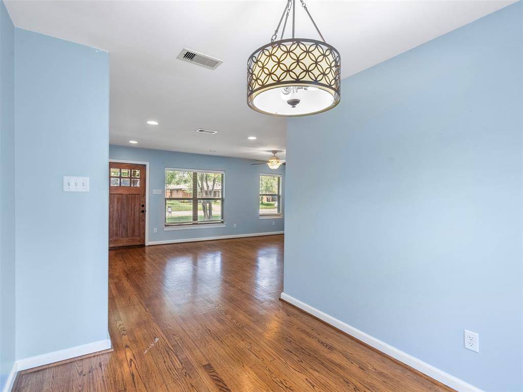 Can we just take a moment to admire these gorgeous original wood floors and all of the natural light in this home?!