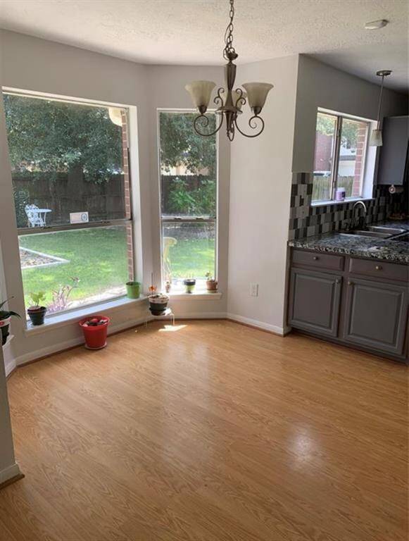 Lovely window in the breakfast nook to gaze into the dreamy oasis backyard
