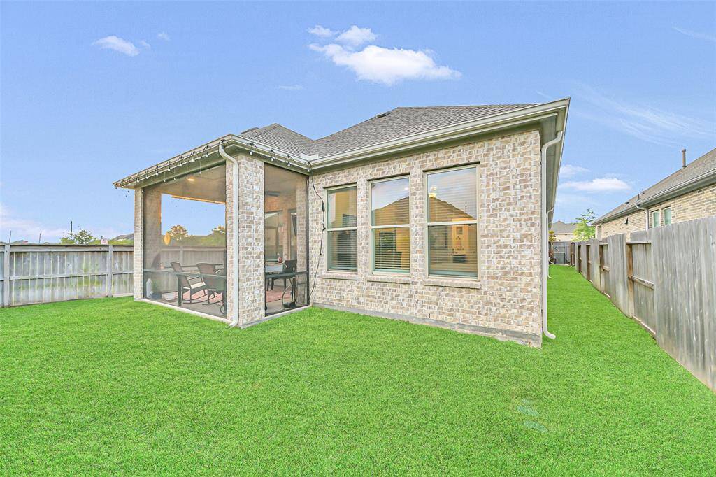 The spacious backyard offers exceptional privacy and endless possibilities, featuring a full fence and a screened-in patio that combines comfort with functionality.