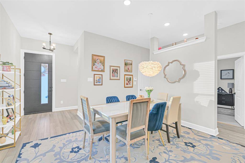 An alternate angle highlights the formal dining room's seamless connection to the entryway and main living spaces.