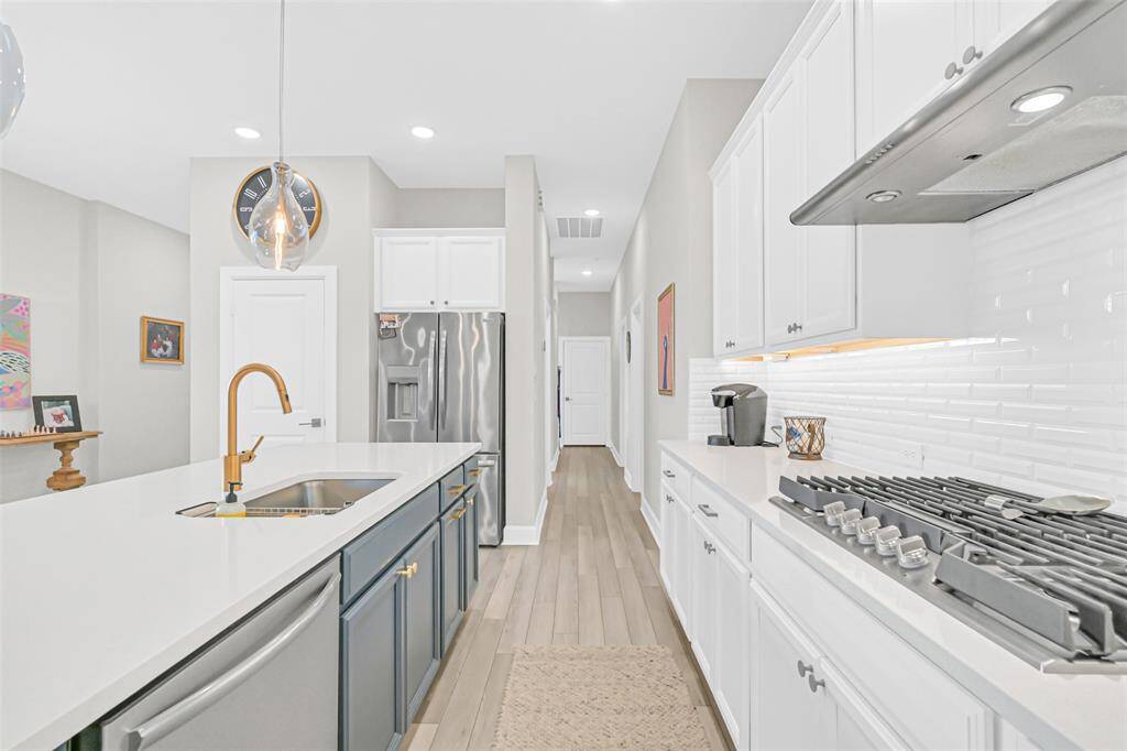 An alternate view reveals how the kitchen seamlessly transitions into the dining area, offering a clear path and open sightlines to the home's living spaces—perfect for staying connected while enjoying a warm meal.