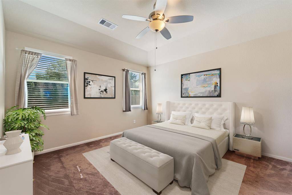Virtually Staged: Unwind in this primary bedroom! It includes carpet floors, a ceiling, and windows with privacy blinds.