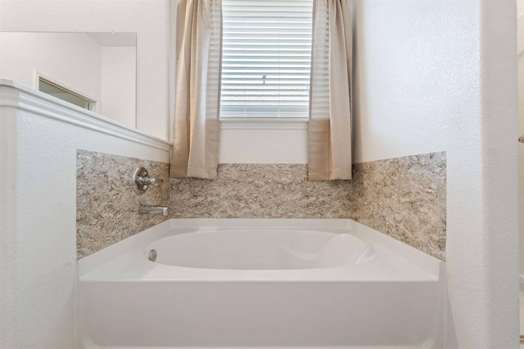 Separate soaking tub with a private window. This will be your new favorite place to sit, drink a glass of wine and relax after a long day!