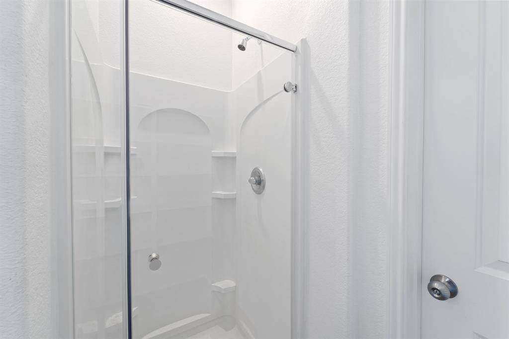 Beautiful walk-in shower with tile walls.