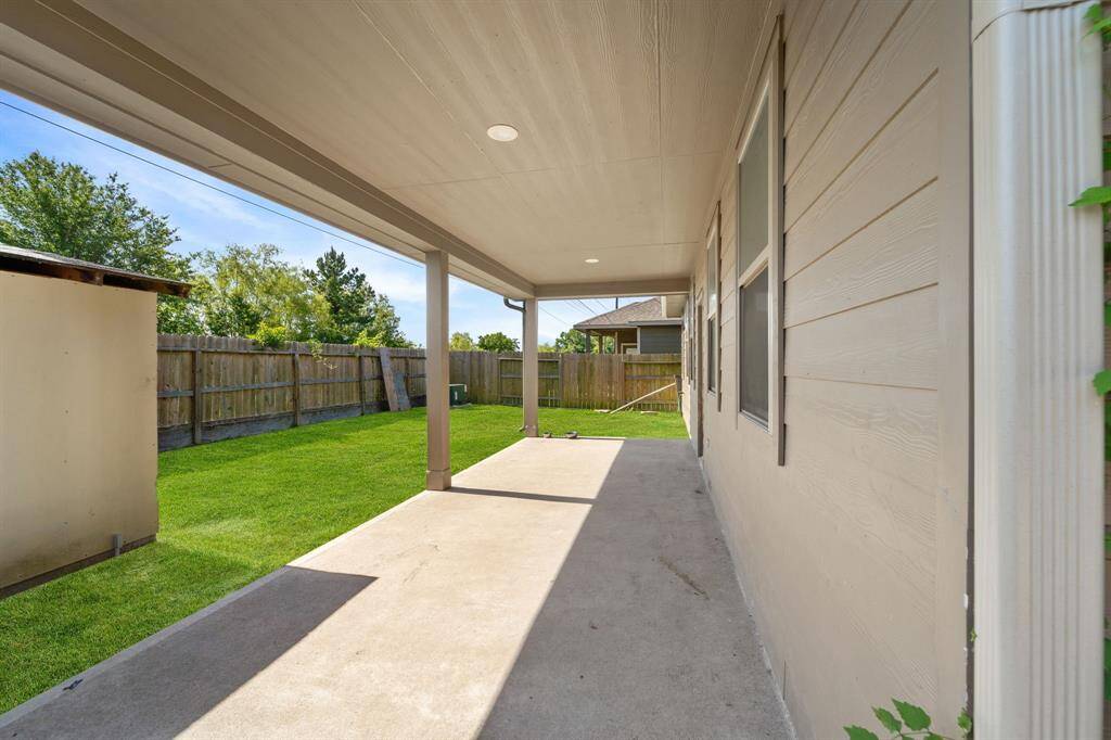 Kick back and relax on the covered backyard patio and enjoy the spacious lawn.