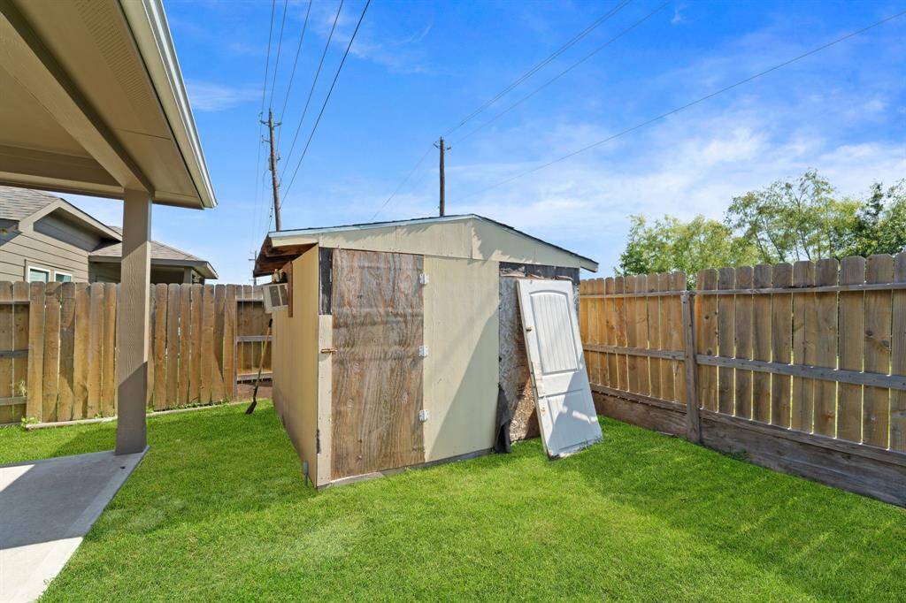 This storage shed is perfect for putting away your gardening tools.