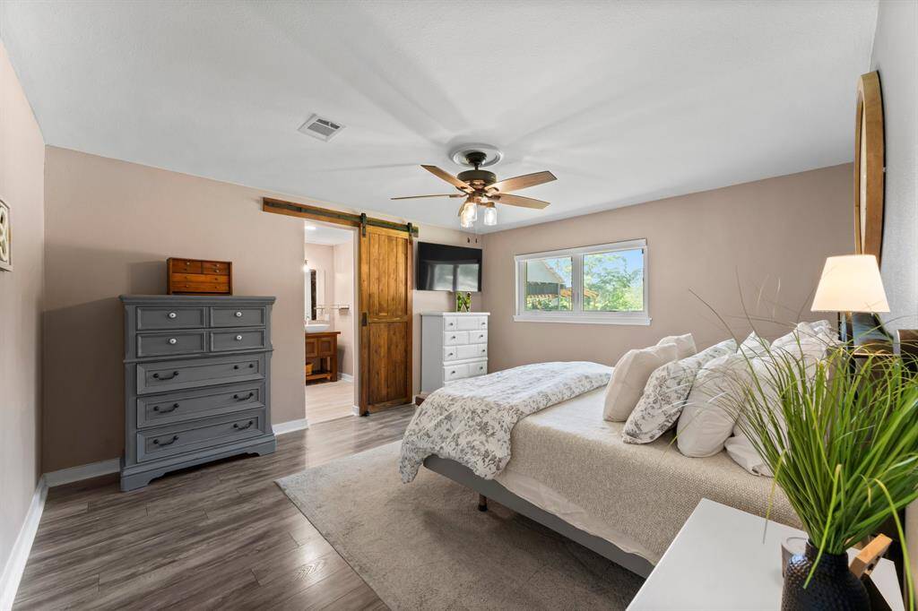 Renovated resort style bathroom offers an oversized walk-in shower with rainfall shower head, dual raised sinks and a walk-in closet.