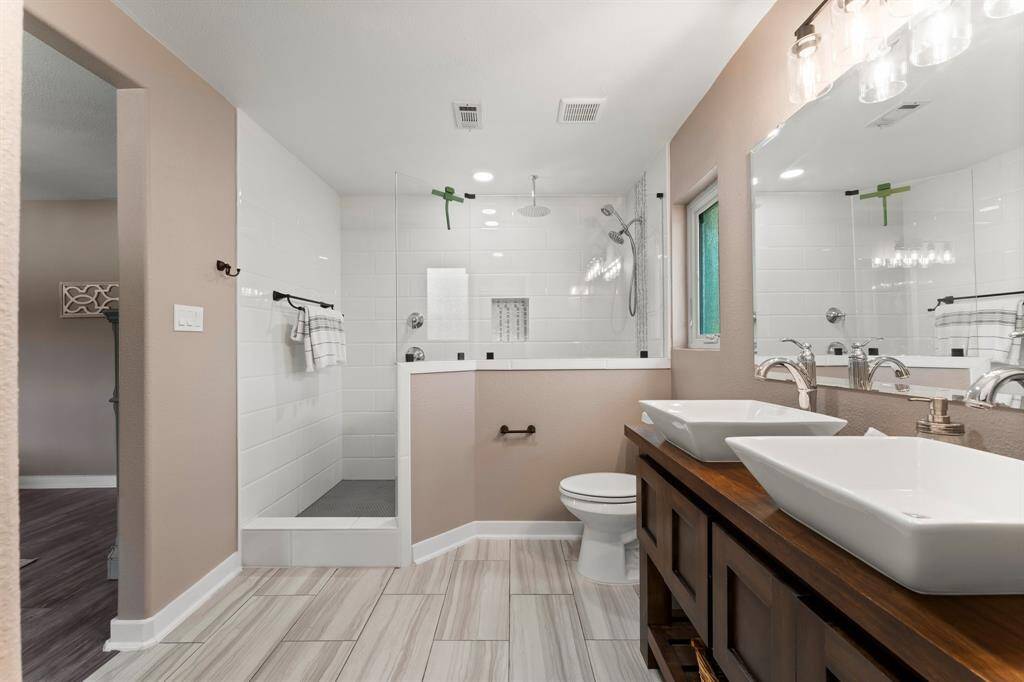 Beautiful tile work and mosaic detailing, along with tasteful light fixtures and faucets.