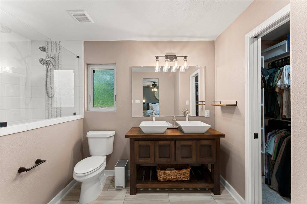 Secondary bedrooms feature ceiling fans and LVP and a fully renovated bathroom.