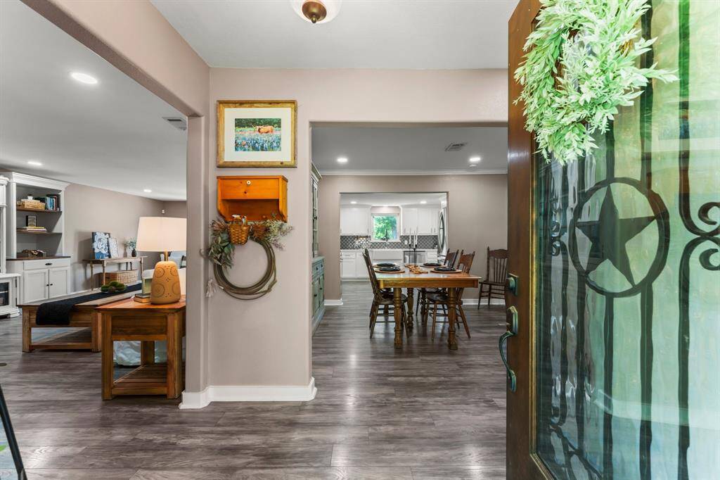 Gorgeously renovated kitchen boasts stainless steel appliances, quartz countertops and farmhouse sink.