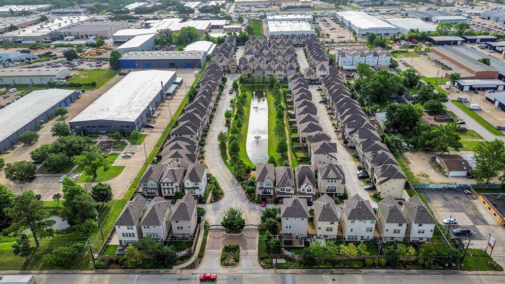 Gated community with a lake and a walking trail.