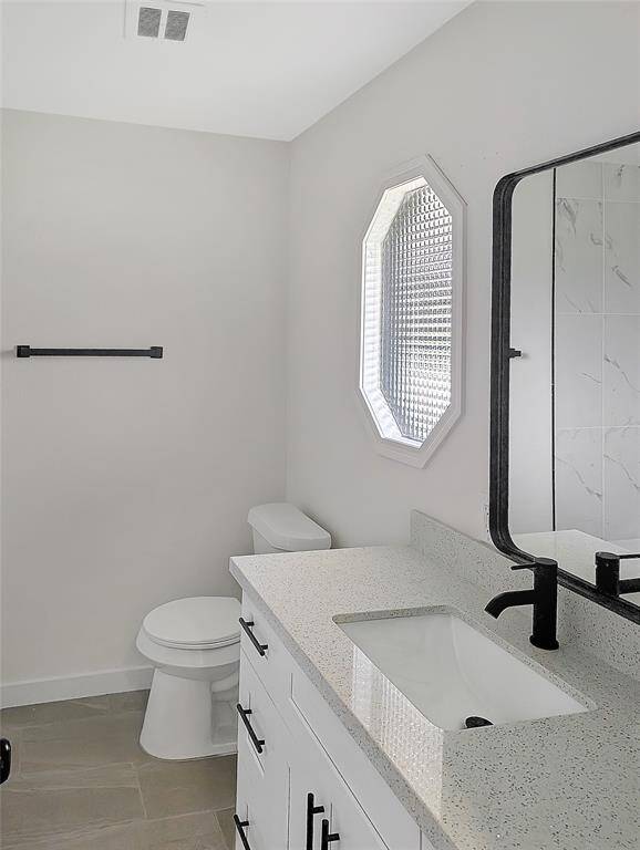 This photo shows a small, well-lit storage area with light-colored walls and tile flooring. It features built-in shelves on both sides, ideal for organizing items efficiently.