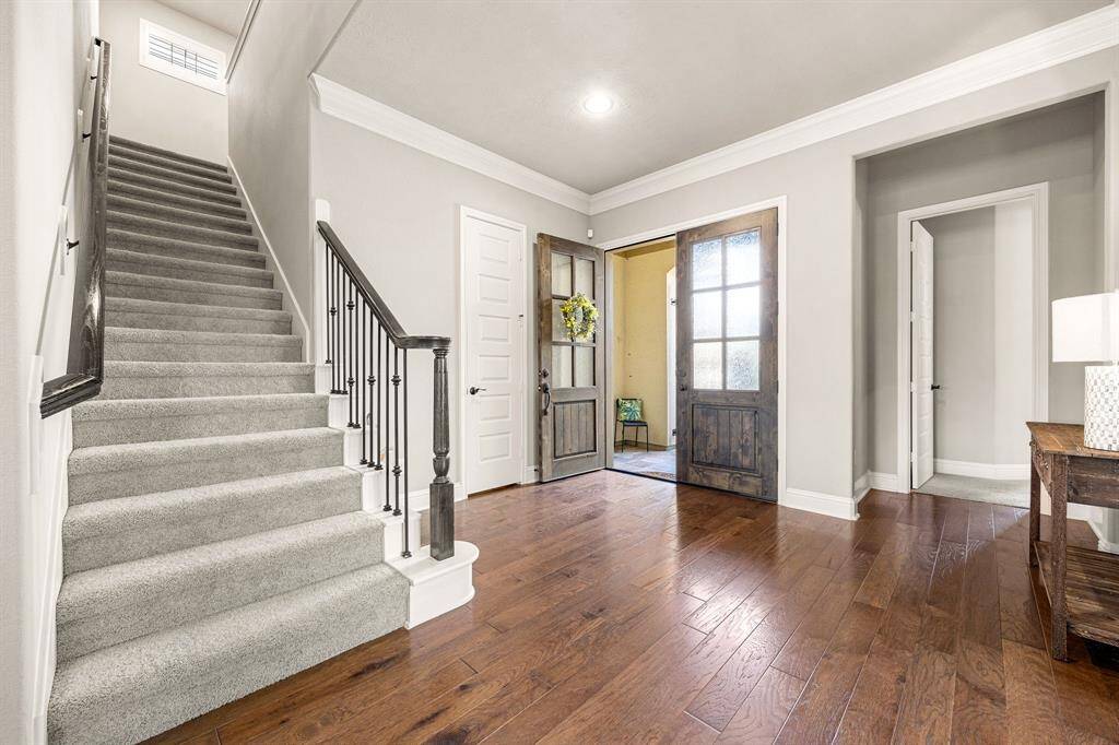 Another view of the grand double doors open to a welcoming foyer.