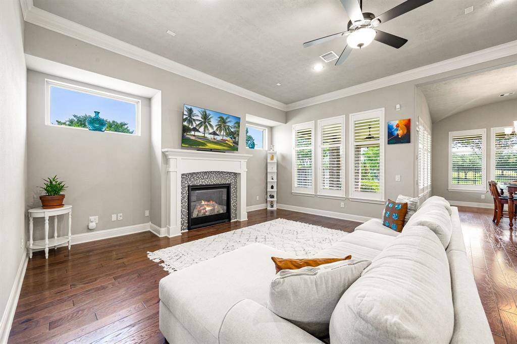 Flooded with natural light from expansive windows, the living room offers a bright and open atmosphere