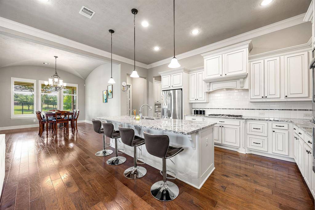 From the heart of the kitchen, take in a beautiful view of the dining room, and backyard. Large windows flood the space with natural light, while easy access to the patio makes indoor-outdoor entertaining a breeze.