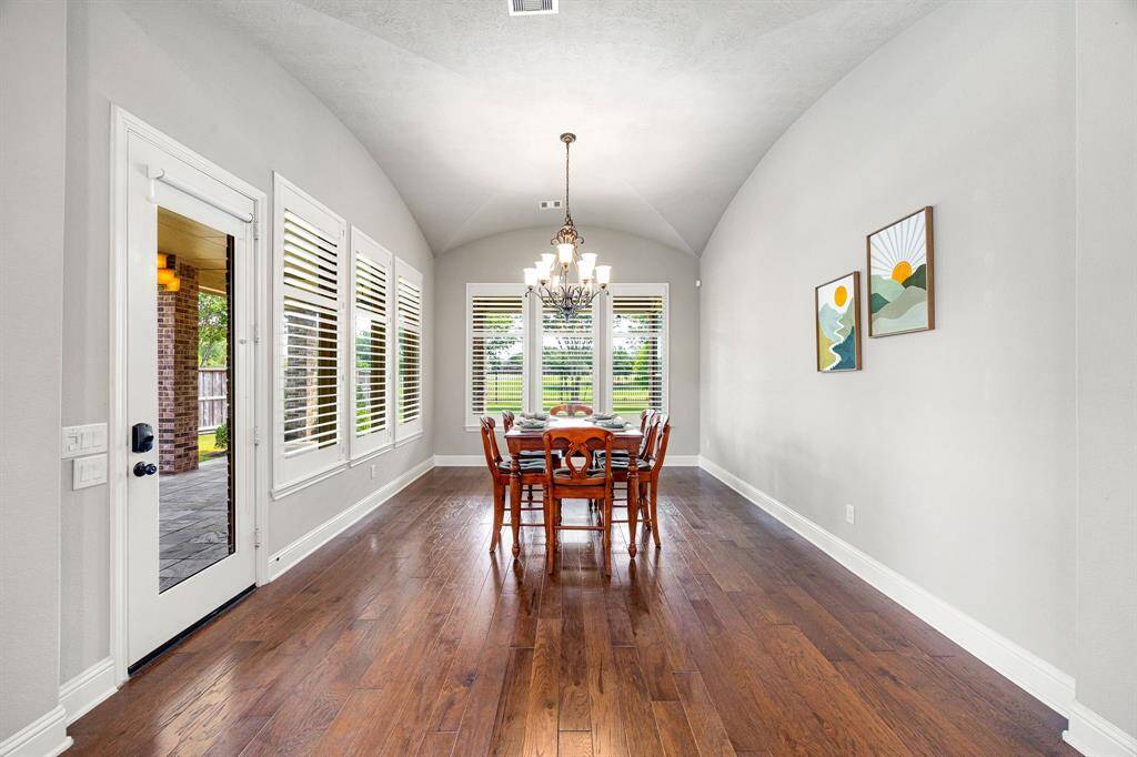 The spacious dining area is filled with natural light, offering beautiful views of the backyard and direct access to the patio. Generously sized to accommodate a larger dining table or additional seating, it’s ideal for everything from family dinners to entertaining guests