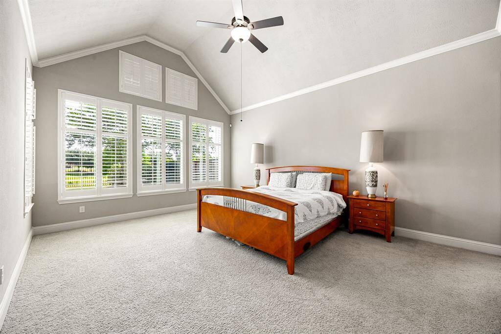 The spacious primary suite offers a serene retreat with room for a sitting area , featuring large windows that bring in natural light and create a calm, airy feel.