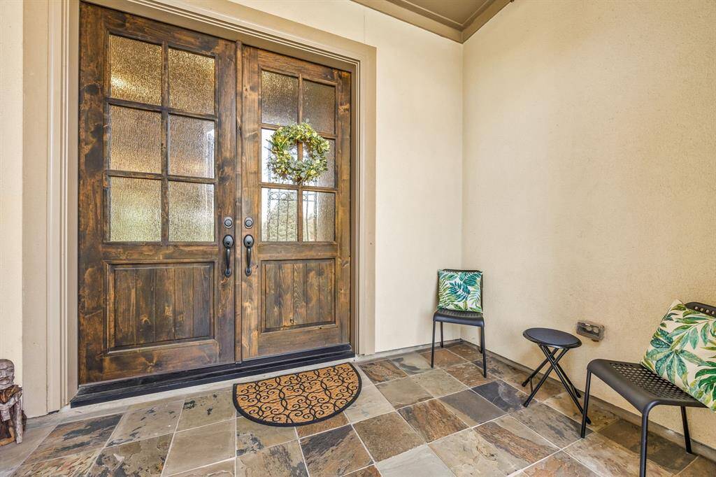 The elegant double door entry makes a grand first impression, offering both style and function as it opens into the heart of the home. It also features a spacious front porch perfect for morning coffee or evening chats.