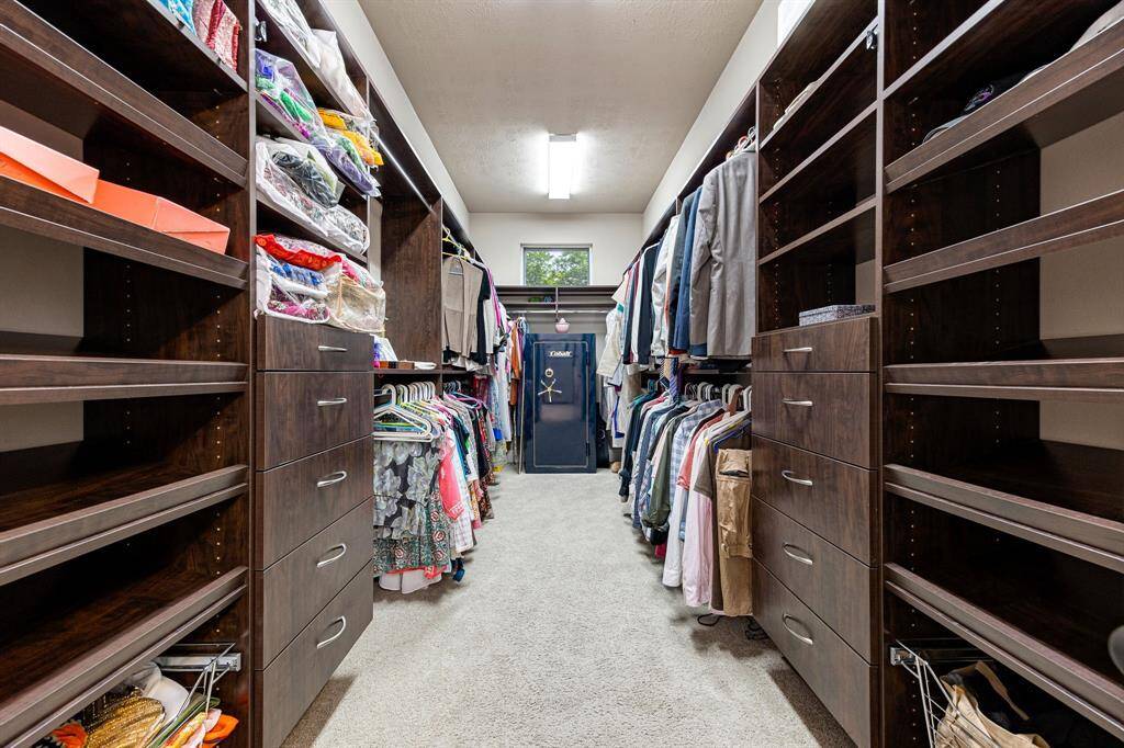Custom-built walk-in closet featuring thoughtfully designed shelving, drawers, and hanging space bringing both luxury and functionality to your everyday routine