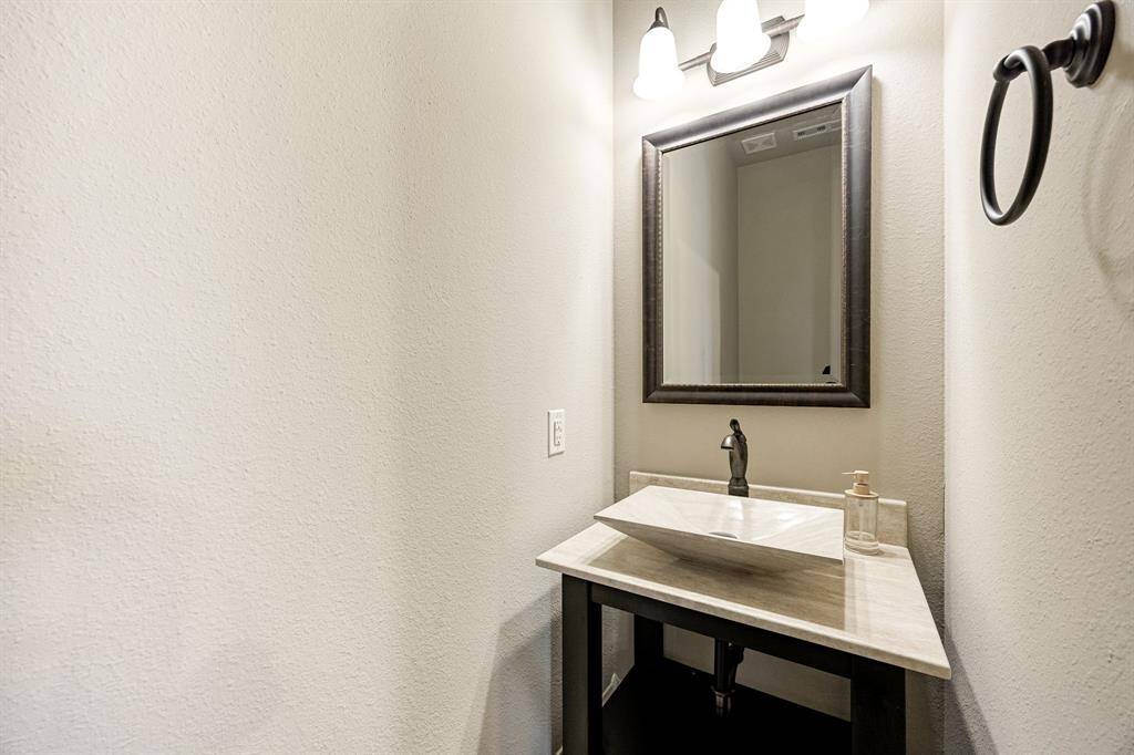 Stylish powder room with elegant finishes perfectly located for guests and everyday convenience.
