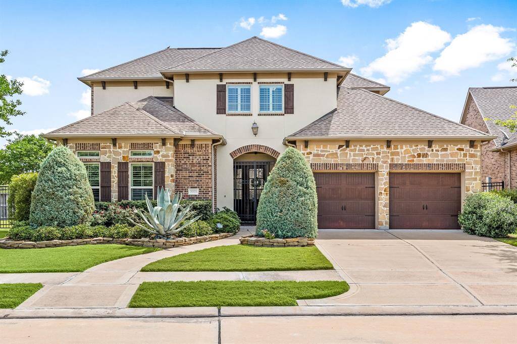 Another view of the stunning stucco, brick and stone elevation and gorgeous landscaping.