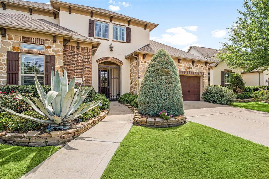 This home sits on a beautifully landscaped 12457 sq ft lot with an oversized patio and water views.