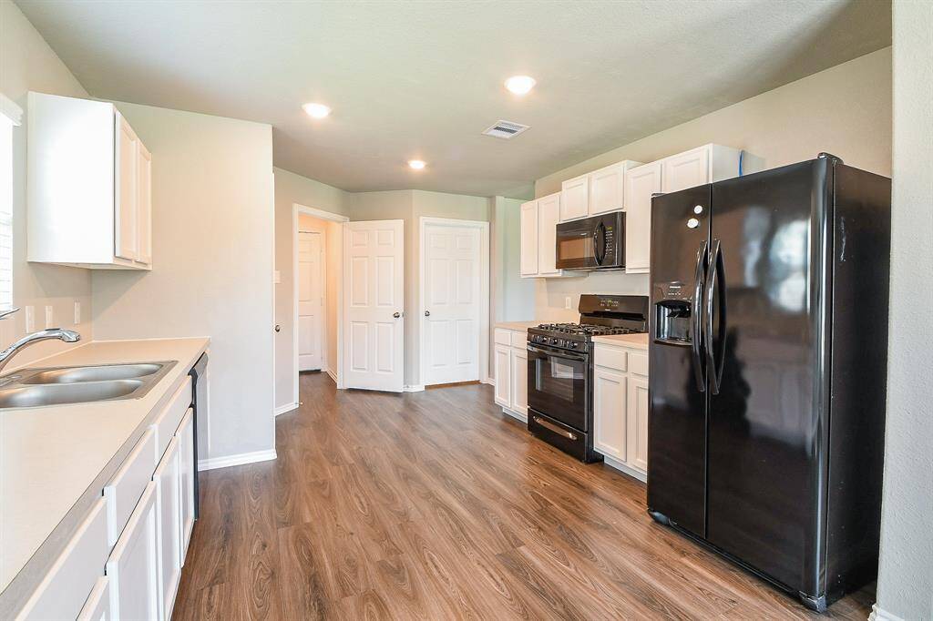 Move right in and enjoy this full white kitchen with black appliances, as all are included for your convenience.