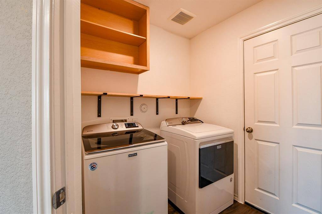 The laundry room offers excellent dimensions, includes a washer and dryer, and provides ample space for organizing your essentials.