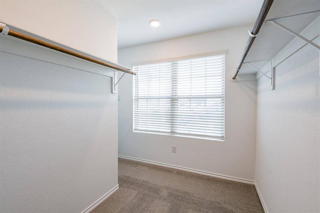 Explore this spacious walk-in closet, designed with her in mind. Don't forget, there's a separate, equally impressive walk-in closet for him.