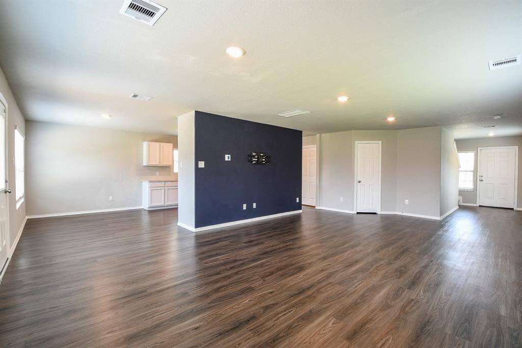 Here's the same living area, shown unfurnished. Please note the blue wall defining the boundary between the living room and kitchen.