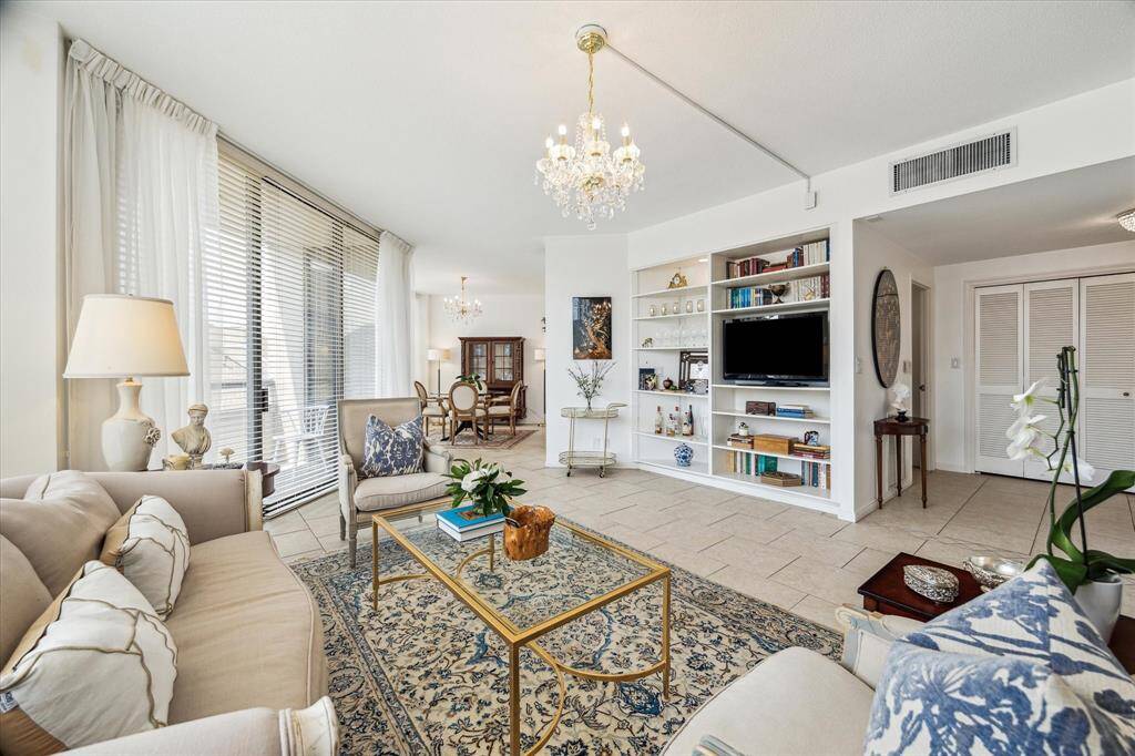 Experience stunning views through floor-to-ceiling windows, showcasing treetops and rooftops with a charming European flair.