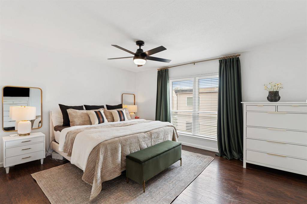 The kitchen features a modern design with green lower cabinets and white upper cabinets, complemented by sleek stainless steel appliances. The space is bright and spacious and has a clean, contemporary look with ample countertop space and a stylish vinyl floor.