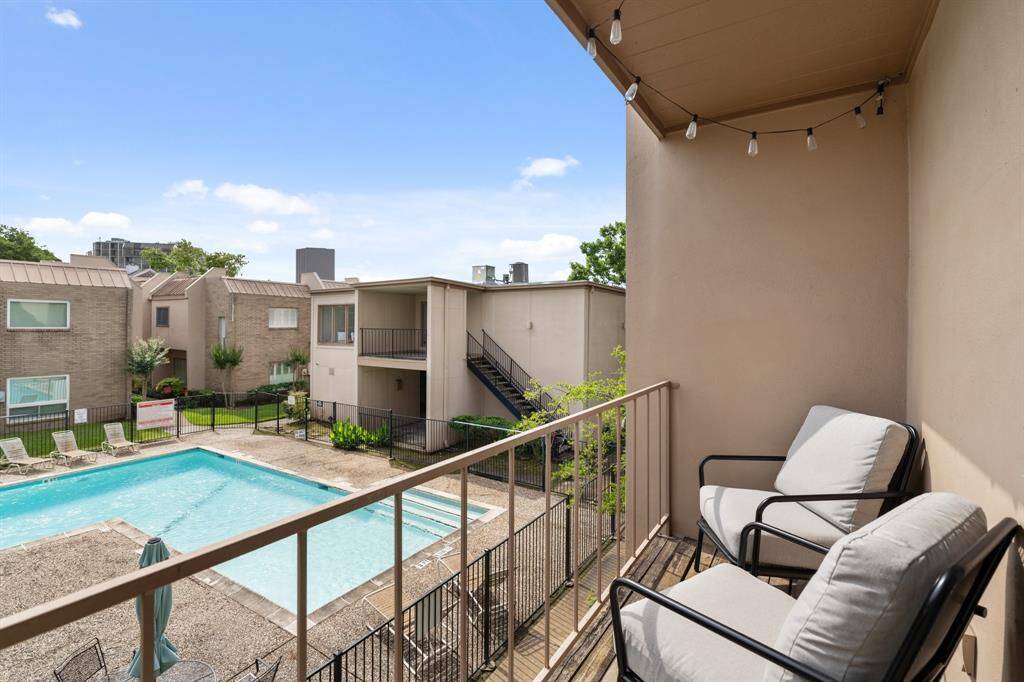 This photo showcases the residential complex featuring a central swimming pool. The area includes lounge chairs and greenery. Also provided is a club/meeting room for residents.